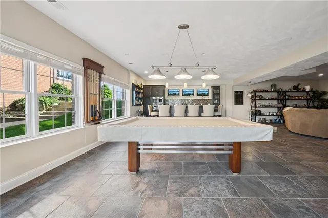 a living room with furniture a chandelier and a large window