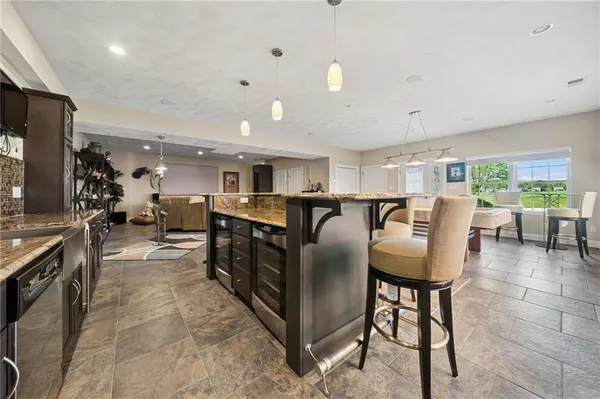 a living room with lots of furniture and kitchen view