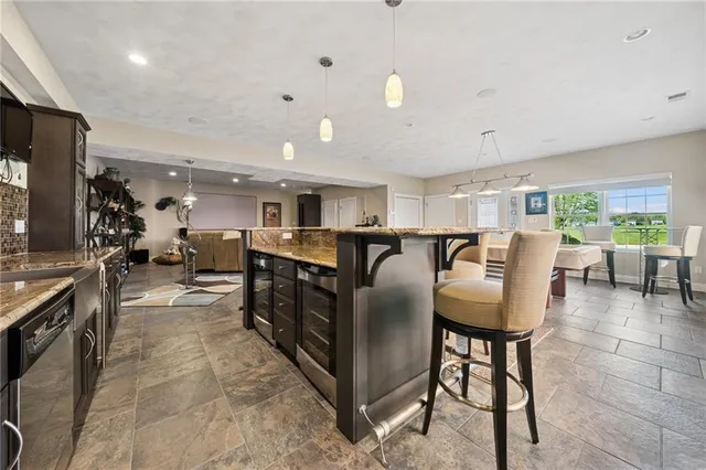 a living room with lots of furniture and kitchen view