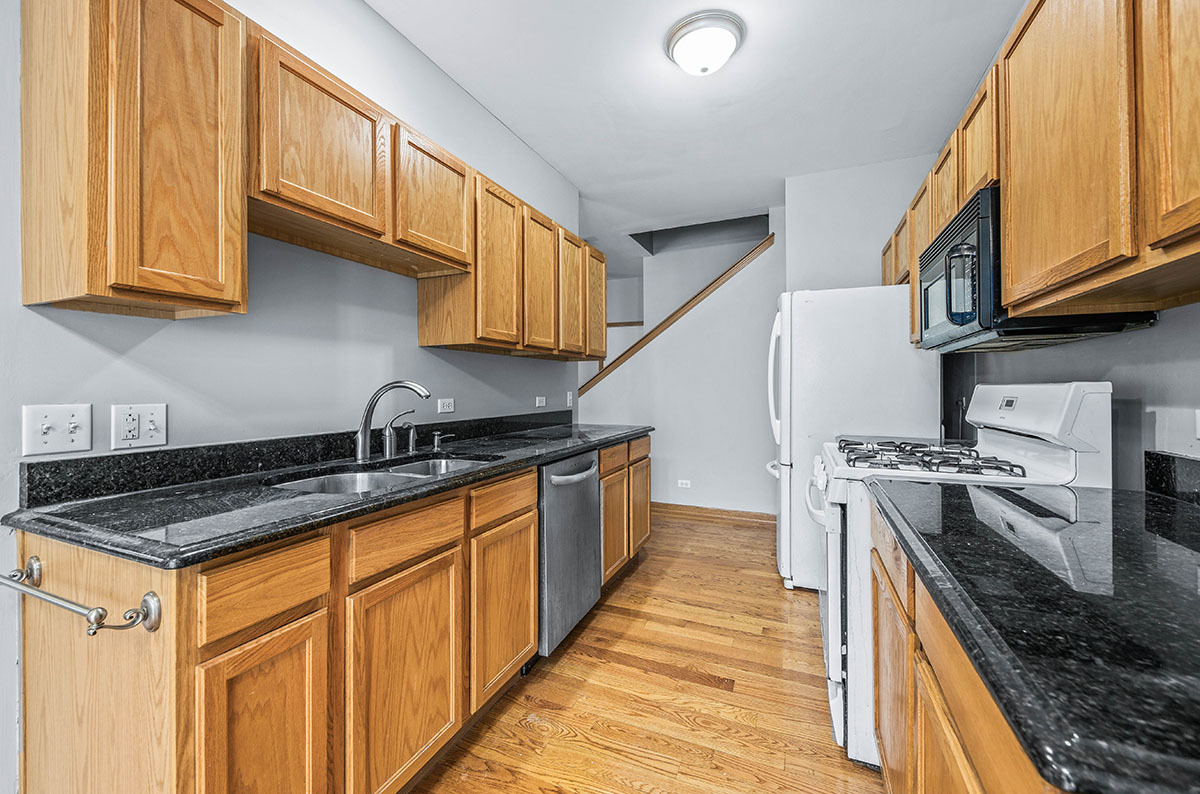 824 County Line Road Aurora, IL 60502 - Photo 6 of 18 a kitchen with stainless steel appliances granite countertop a stove a sink and a microwave
