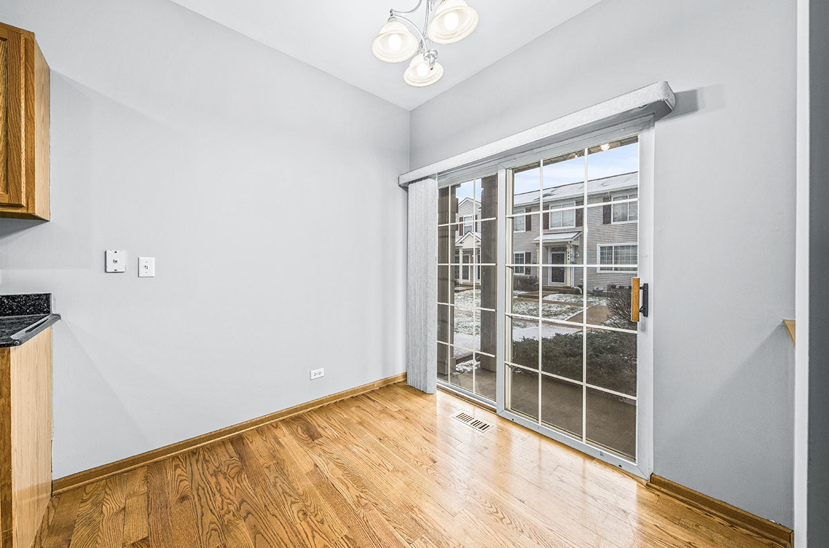 824 County Line Road Aurora, IL 60502 - Photo 9 of 18 a view of empty room with wooden floor and fan