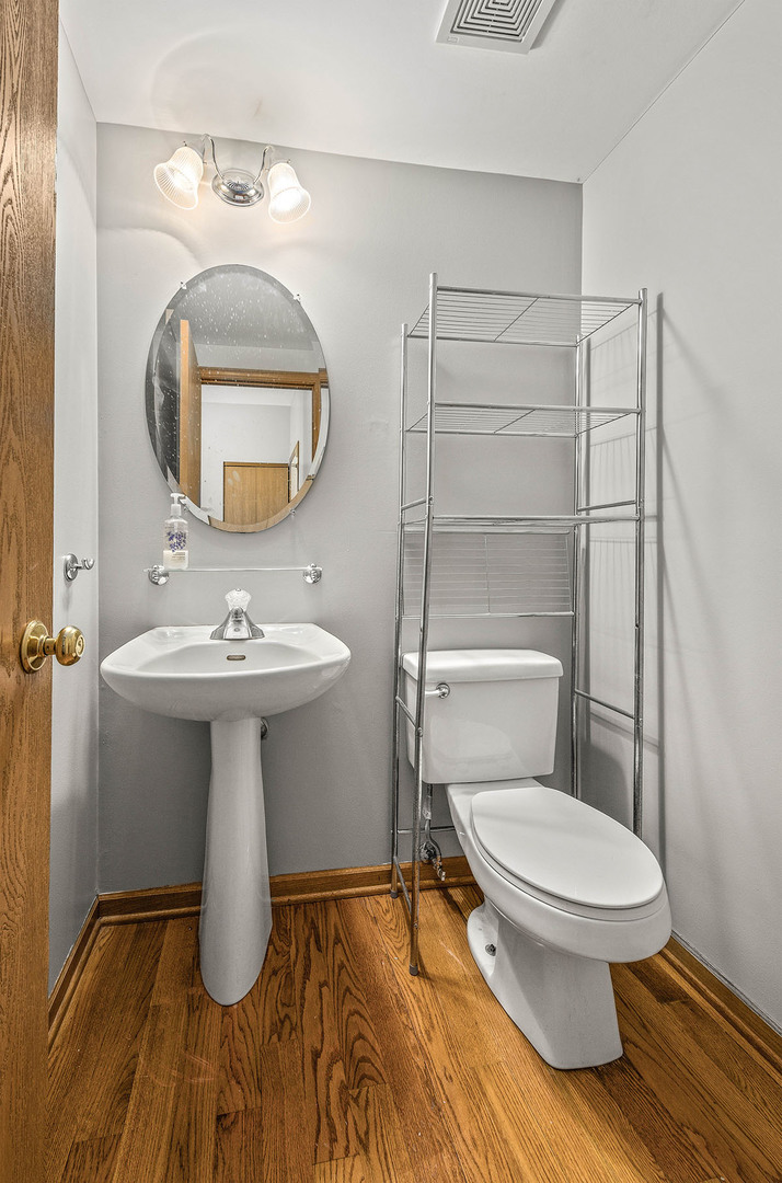 824 County Line Road Aurora, IL 60502 - Photo 10 of 18 a bathroom with a sink toilet and mirror