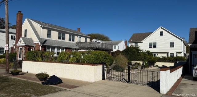 86 Lynbrook Avenue Point Lookout, NY 11569 - Photo 3 of 8 a view of a white house with a yard and balcony