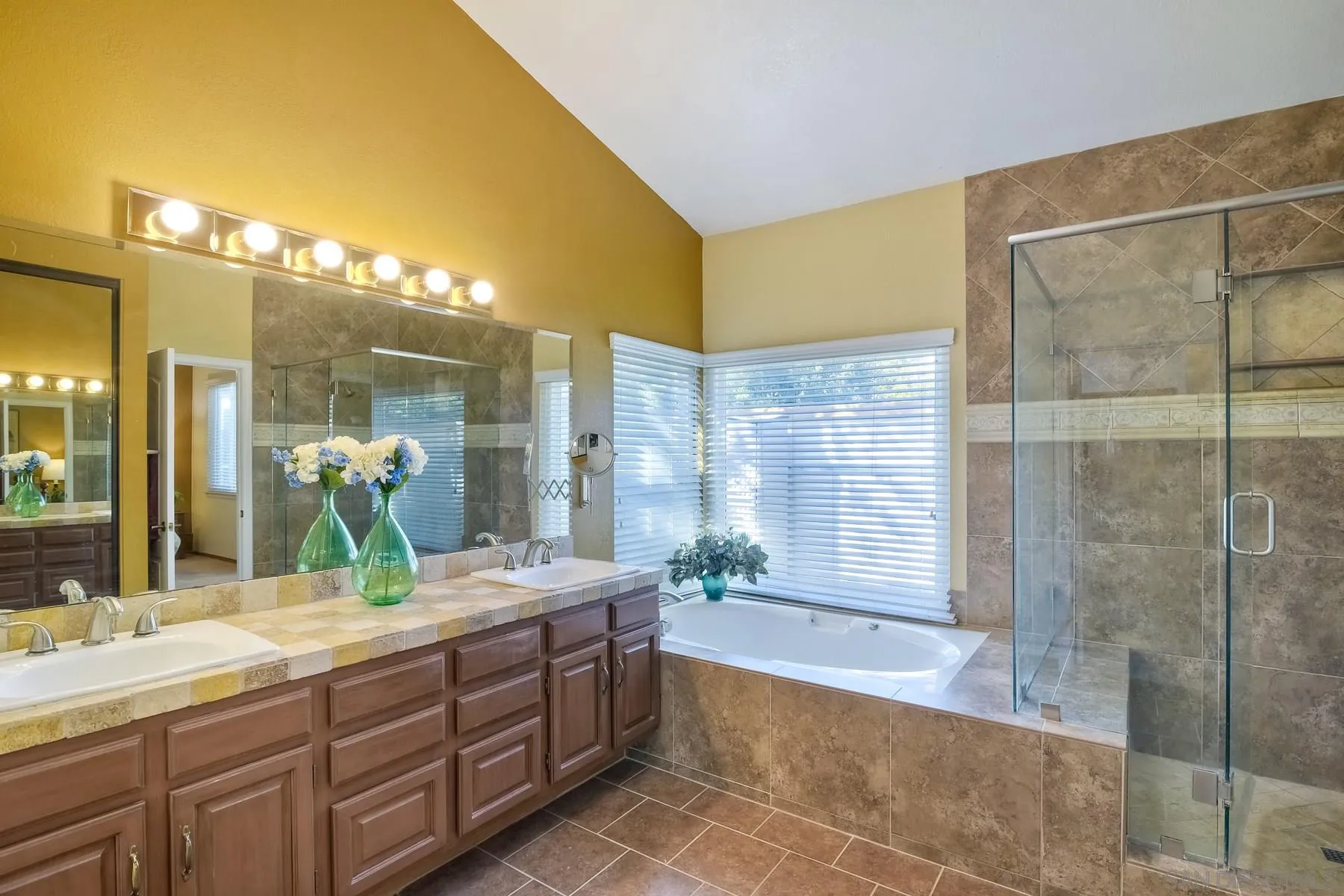 13892 Oakstand Road Poway, CA 92064 - Photo 12 of 27 a bathroom with a granite countertop sink a large mirror and a bathtub