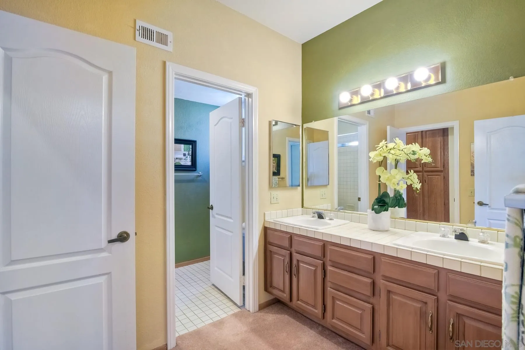 13892 Oakstand Road Poway, CA 92064 - Photo 14 of 27 a spacious bathroom with a double vanity sink a large mirror and a shower