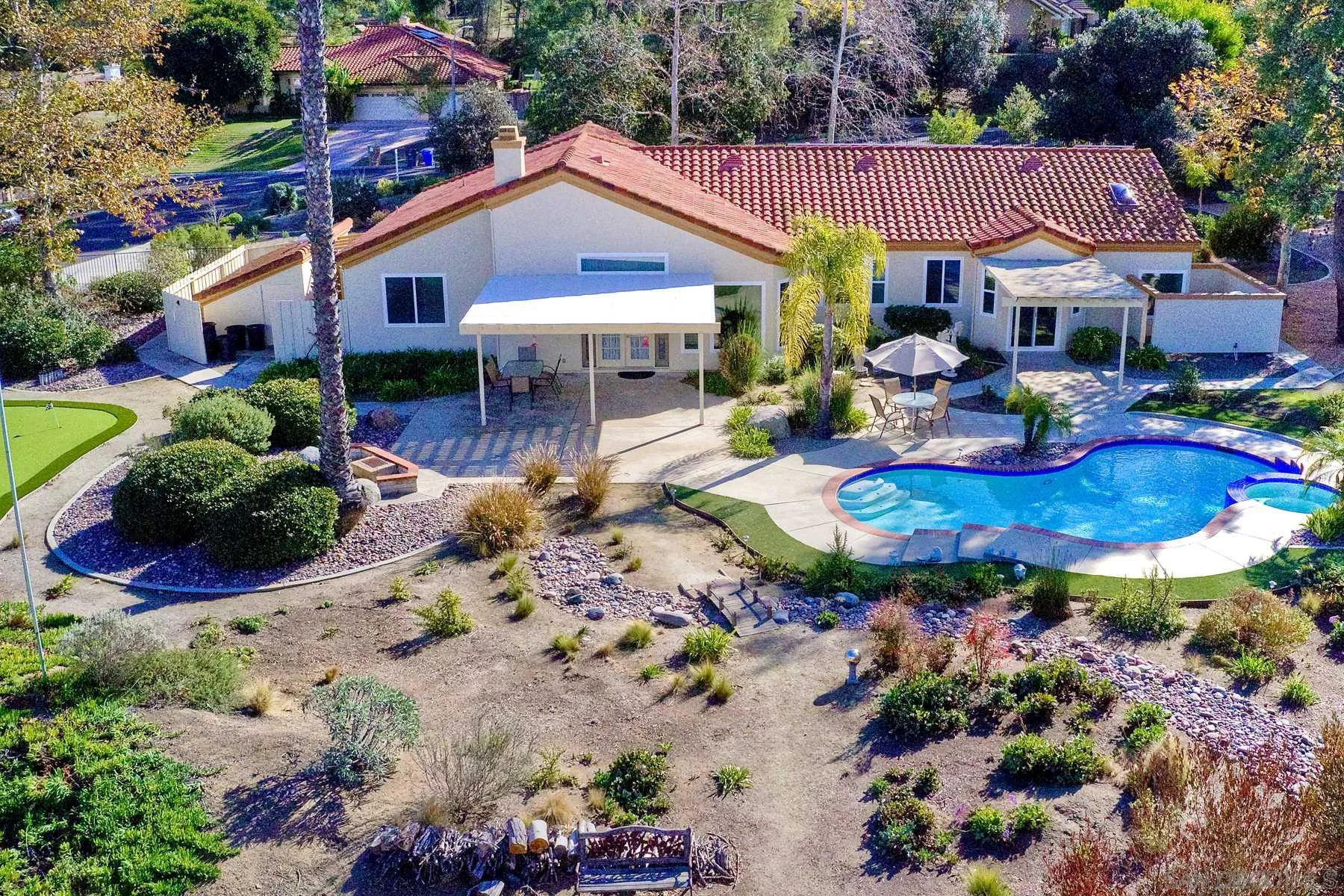 13892 Oakstand Road Poway, CA 92064 - Photo 23 of 27 a view of a house with swimming pool lawn chairs and a yard tree s