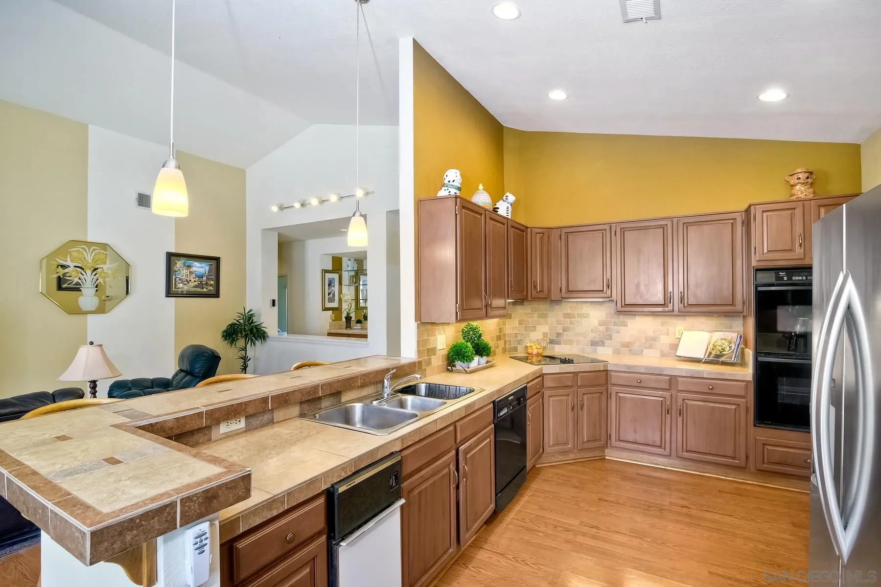 13892 Oakstand Road Poway, CA 92064 - Photo 7 of 27 a kitchen with a sink refrigerator and cabinets