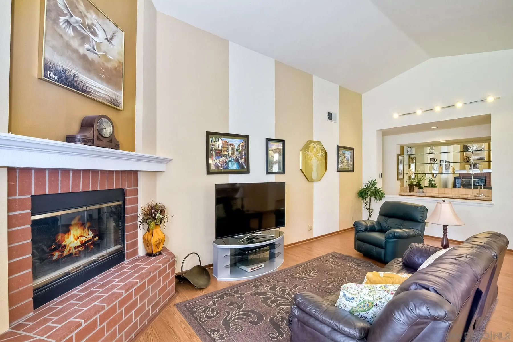 13892 Oakstand Road Poway, CA 92064 - Photo 9 of 27 a living room with furniture a flat screen tv and a fireplace
