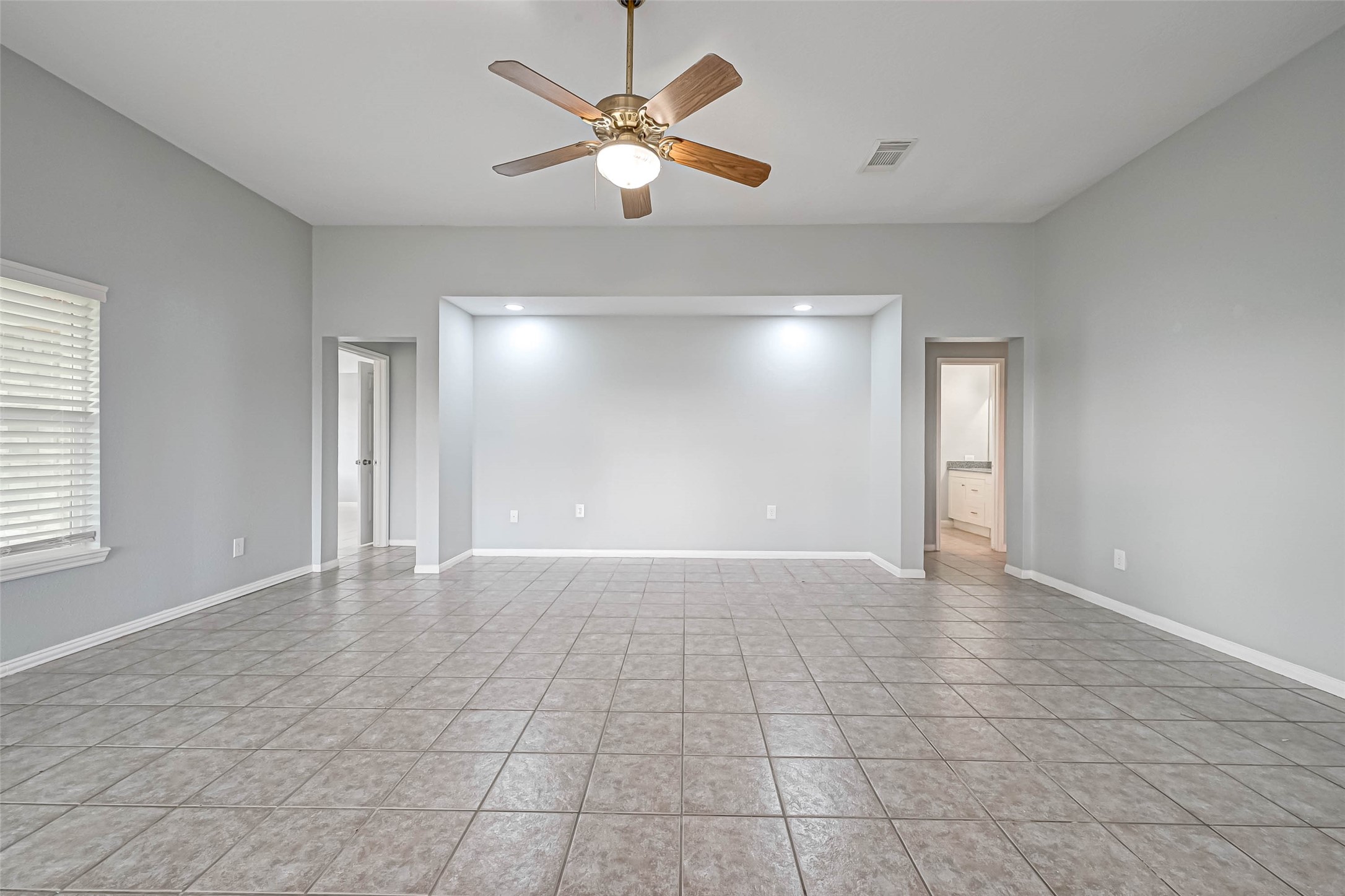 7520 Vincik Ehlert Road Rosenberg, TX 77471 - Photo 13 of 46 a view of an empty room with window and chandelier fan