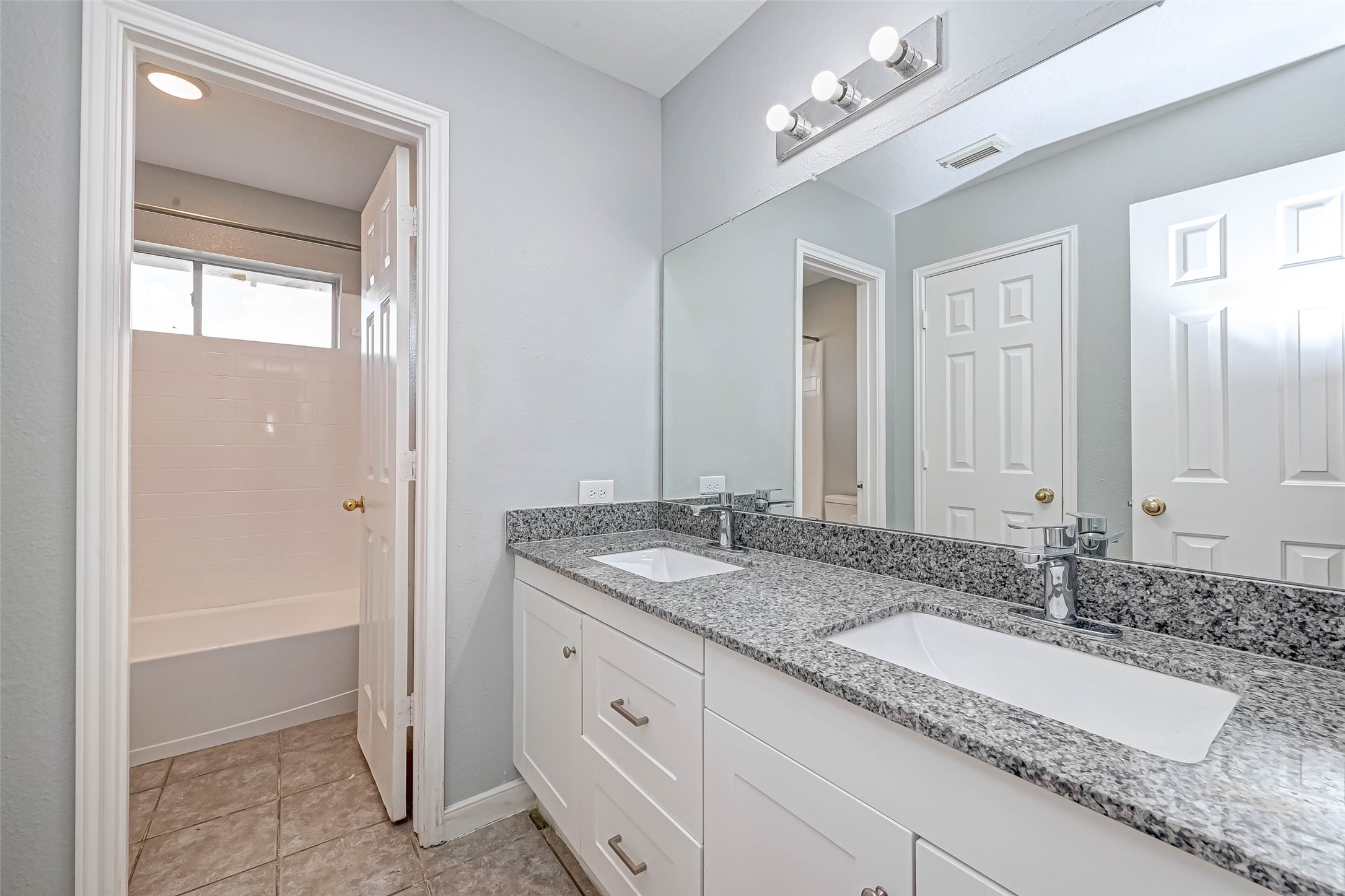 7520 Vincik Ehlert Road Rosenberg, TX 77471 - Photo 27 of 46 a bathroom with a granite countertop sink and a mirror