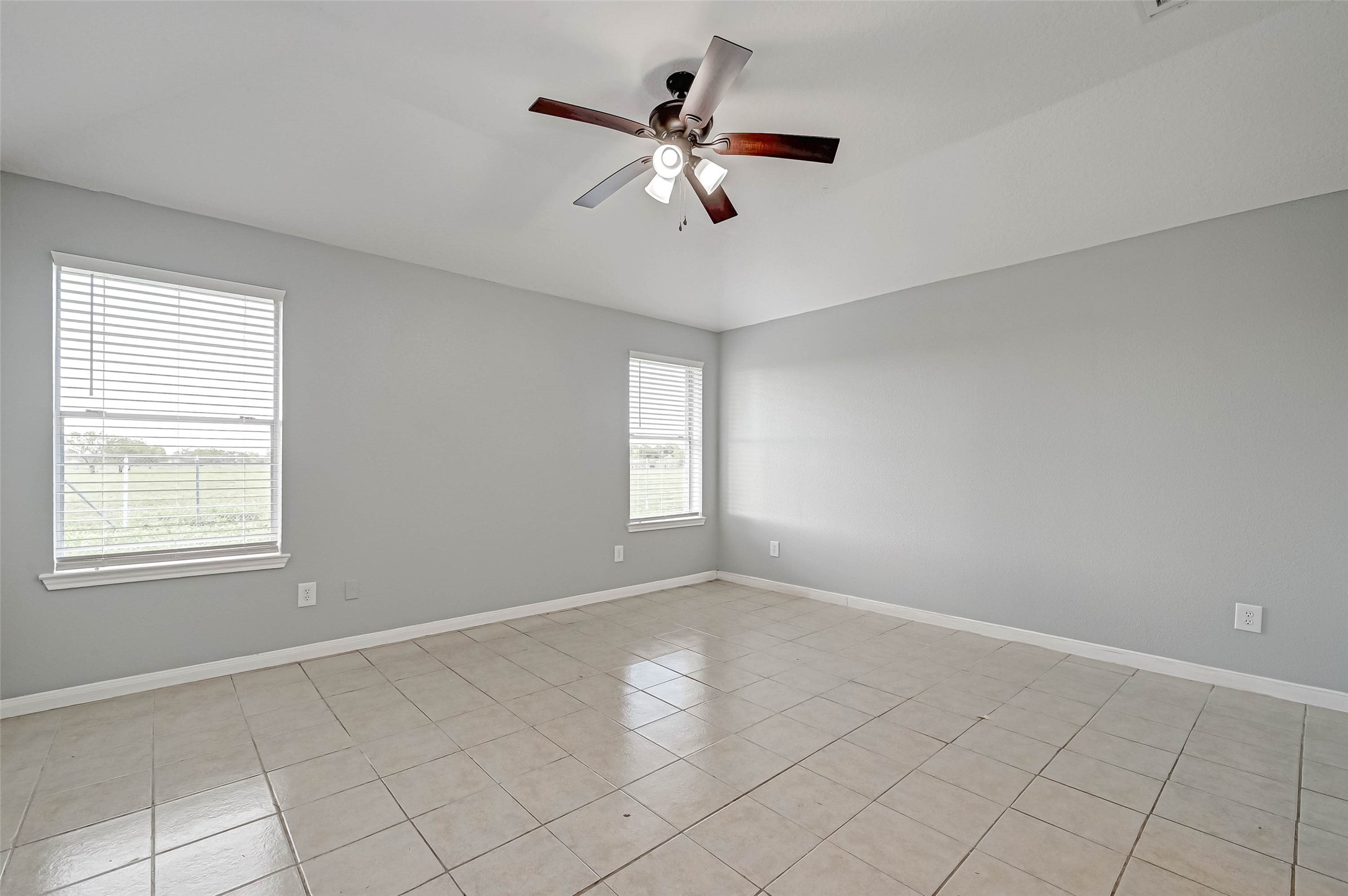 7520 Vincik Ehlert Road Rosenberg, TX 77471 - Photo 32 of 46 a view of an empty room with chandelier fan and fire place