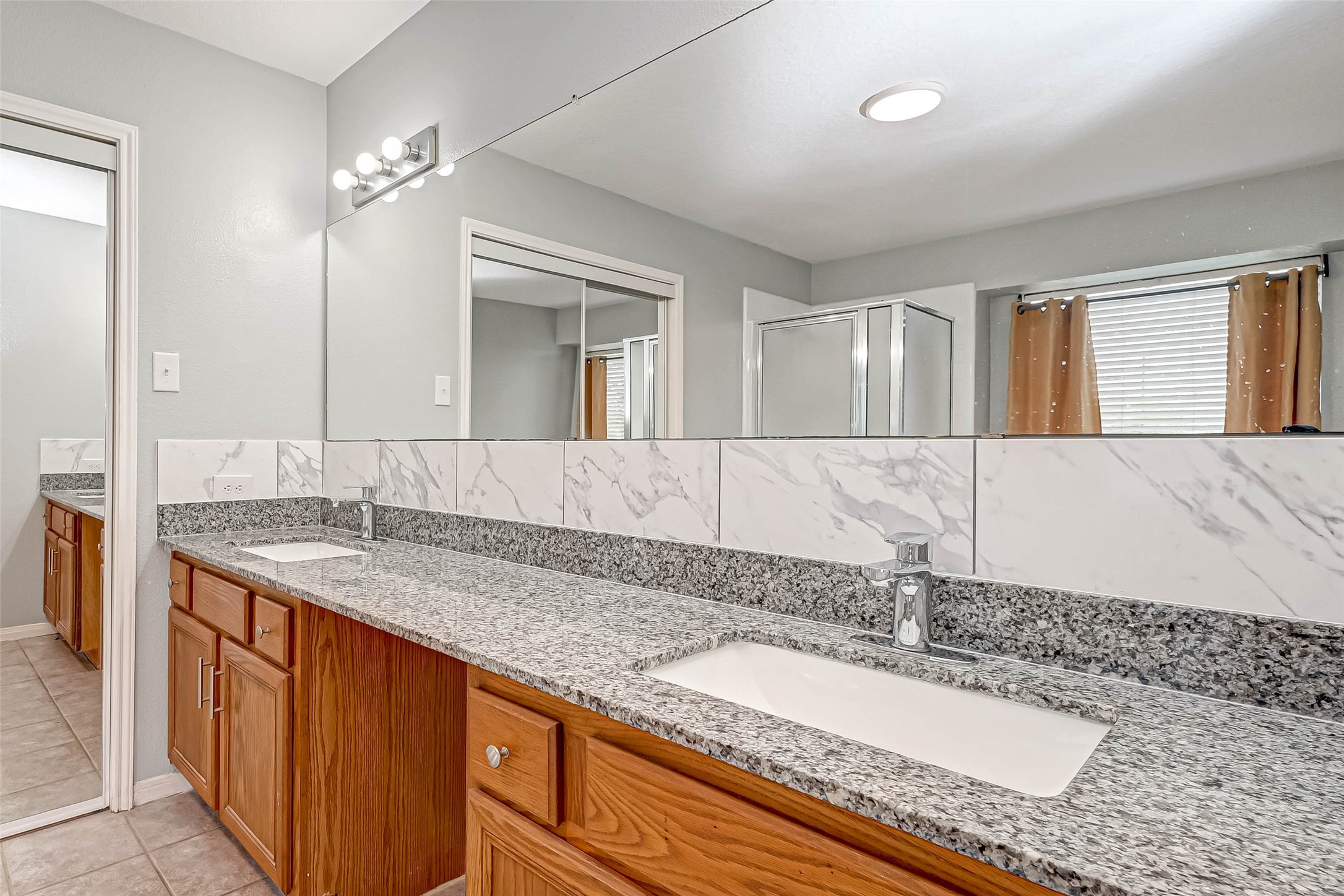 7520 Vincik Ehlert Road Rosenberg, TX 77471 - Photo 36 of 46 a bathroom with a granite countertop sink and a mirror