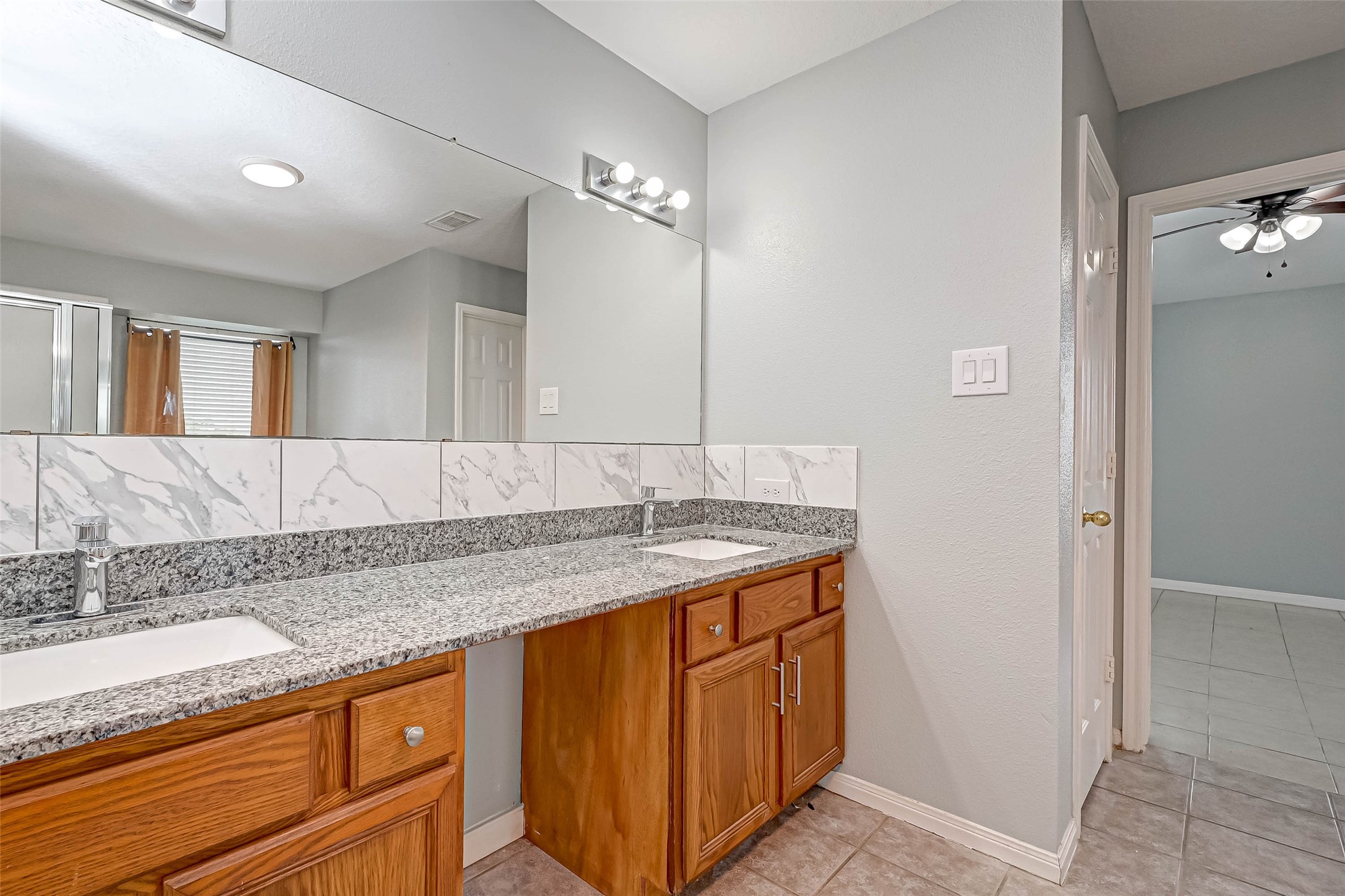 7520 Vincik Ehlert Road Rosenberg, TX 77471 - Photo 40 of 46 a bathroom with a granite countertop sink and a mirror
