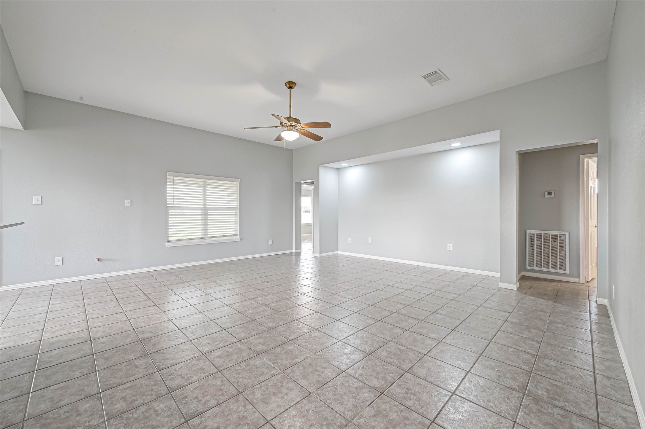 7520 Vincik Ehlert Road Rosenberg, TX 77471 - Photo 9 of 46 a view of an empty room with window and chandelier fan
