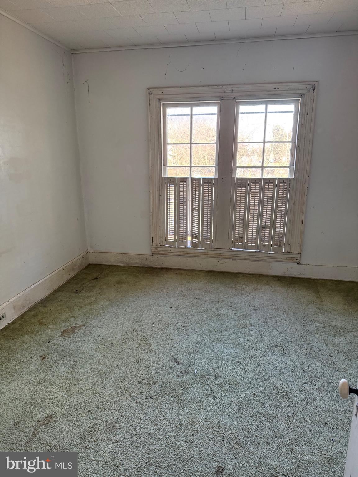 564 Front Street Houston, DE 19954 - Photo 16 of 34 an empty room with wooden floor and windows