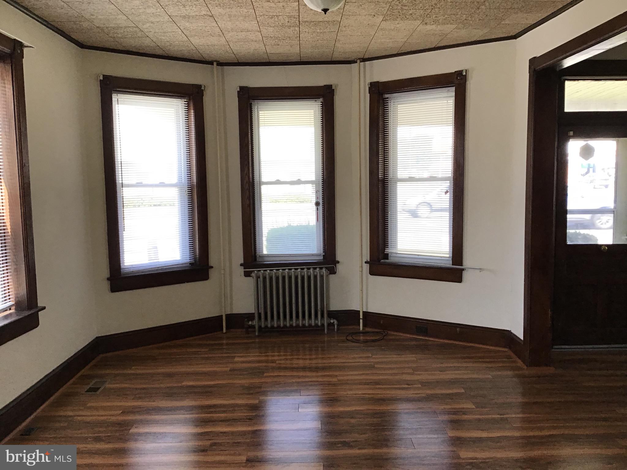 1822 East Main Street Waynesboro, PA 17268 - Photo 4 of 21 an empty room with wooden floor and windows