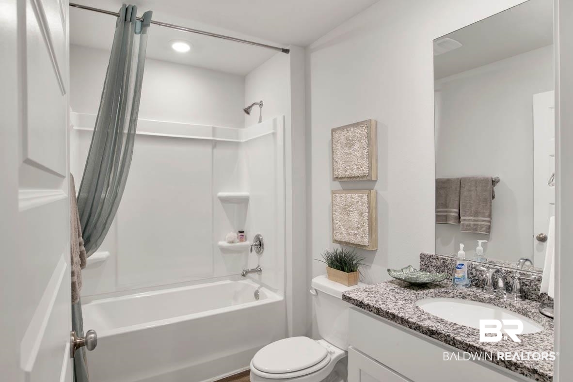 1235 Hayward Loop Foley, AL 36535 - Photo 24 of 26 Full bathroom with shower / bath combination with curtain, toilet, and vanity