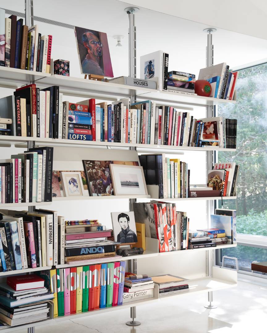 78 Windmill Lane Water Mill, NY 11976 - Photo 11 of 26 a living room with lots of books cabinets a bed and a book shelf