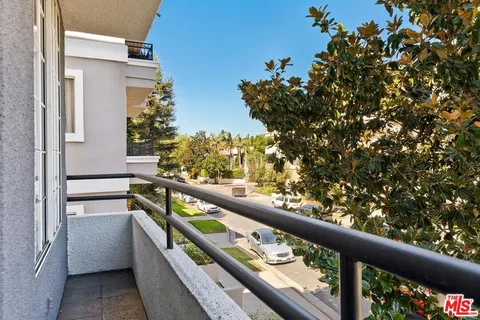 a balcony with wooden floor and outdoor seating