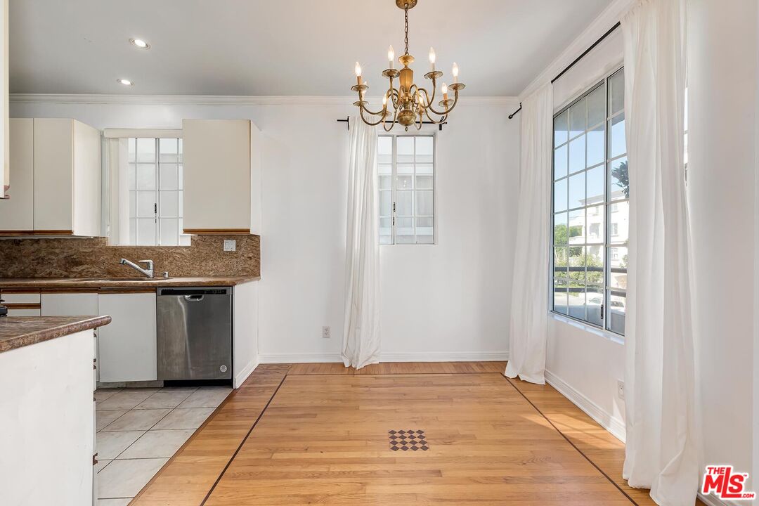 1169 Wellesley Avenue, Unit 101 Los Angeles, CA 90049 - Photo 12 of 26 a view of a kitchen with granite countertop cabinets a counter and a sink