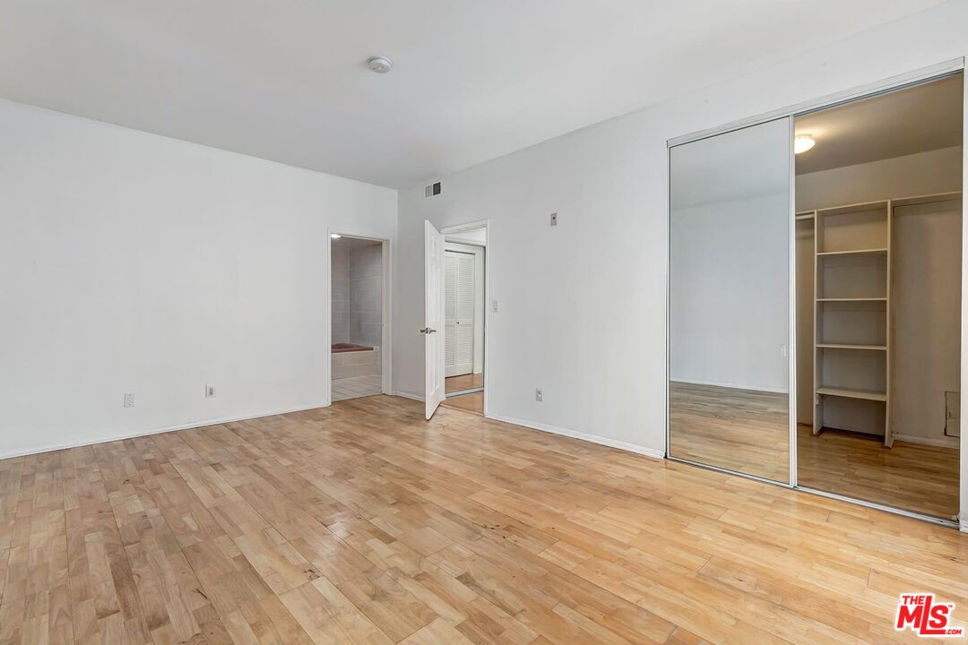 1169 Wellesley Avenue, Unit 101 Los Angeles, CA 90049 - Photo 18 of 26 a view of an empty room with wooden floor and closet