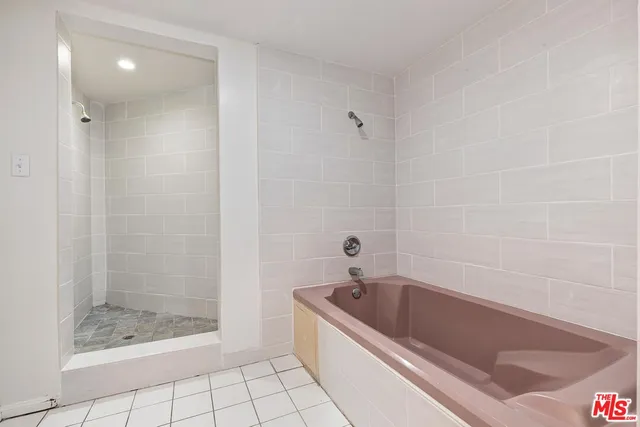 a bathroom with a bathtub and a shower