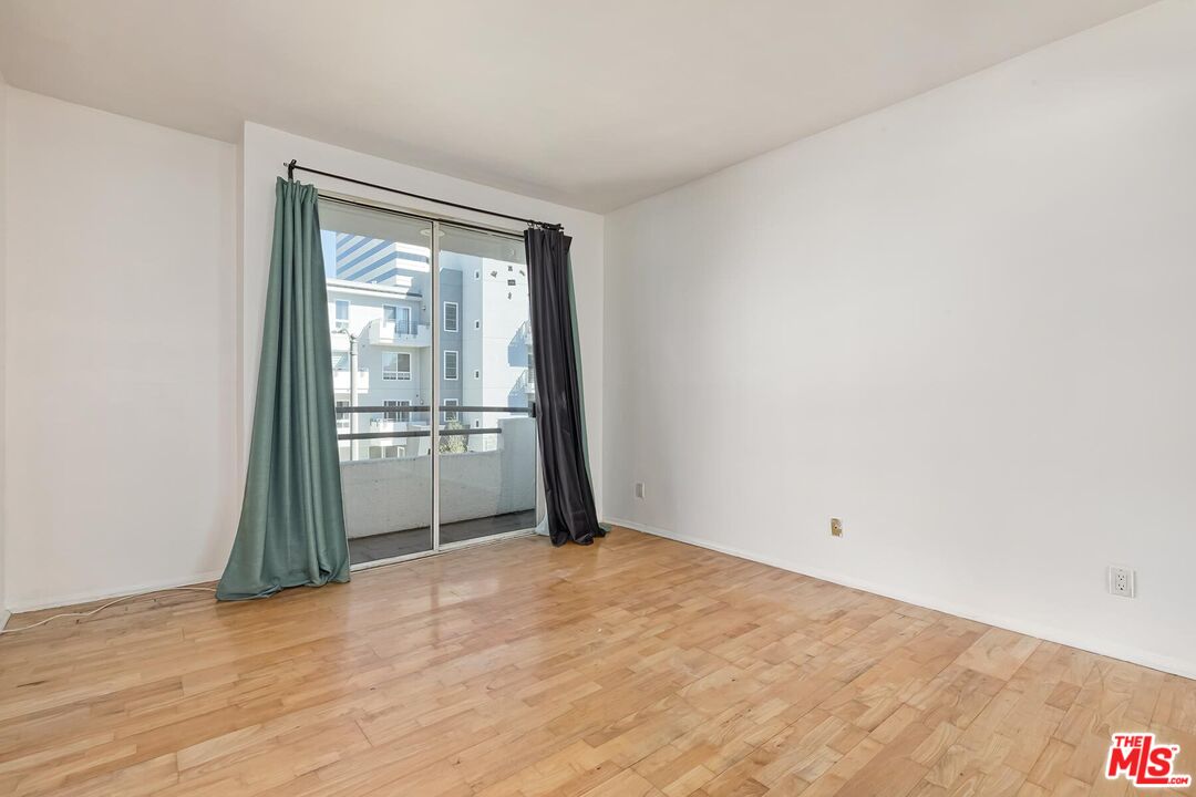 1169 Wellesley Avenue, Unit 101 Los Angeles, CA 90049 - Photo 23 of 26 a view of empty room with wooden floor