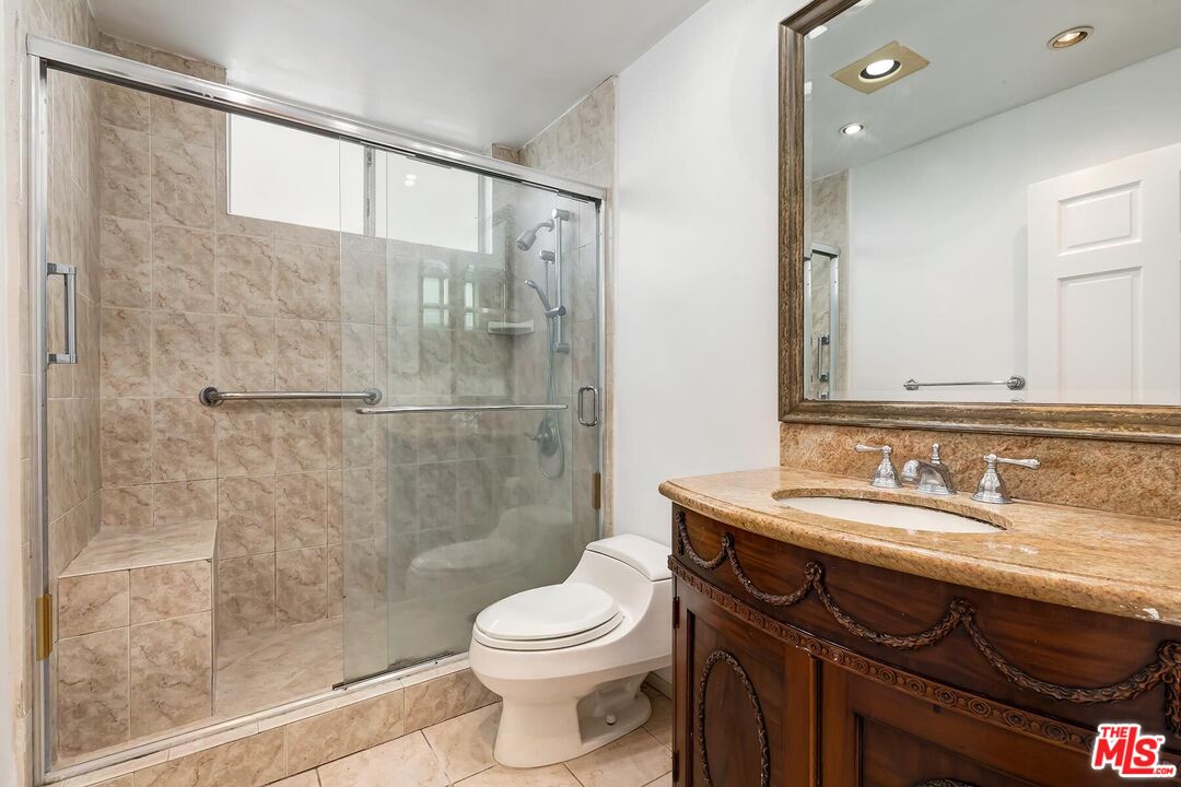 1169 Wellesley Avenue, Unit 101 Los Angeles, CA 90049 - Photo 25 of 26 a bathroom with a sink a toilet and shower