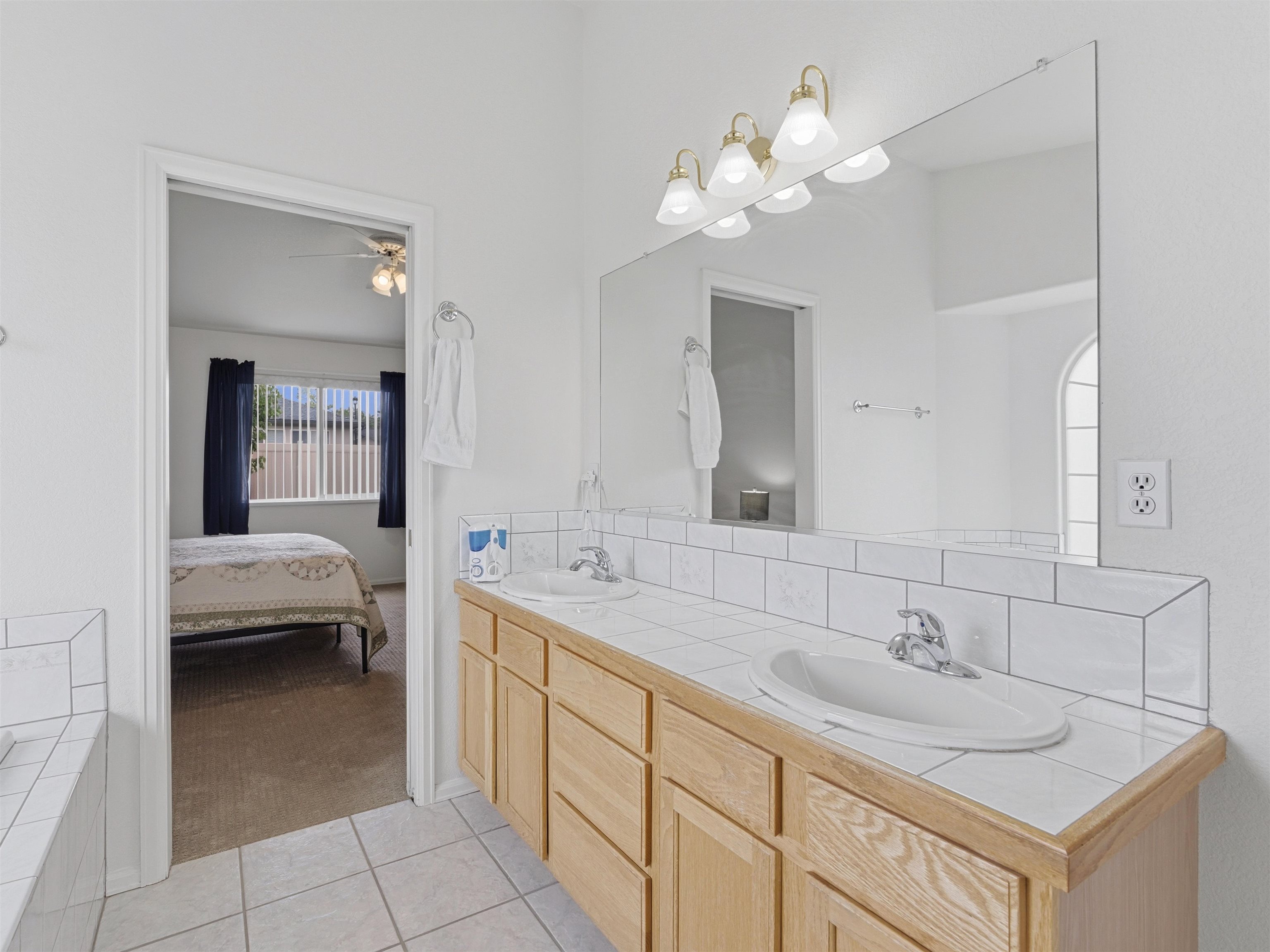 3082 Shadowbrook Court Grand Junction, CO 81504 - Photo 14 of 28 a spacious en suite bathroom with a double sink and mirror