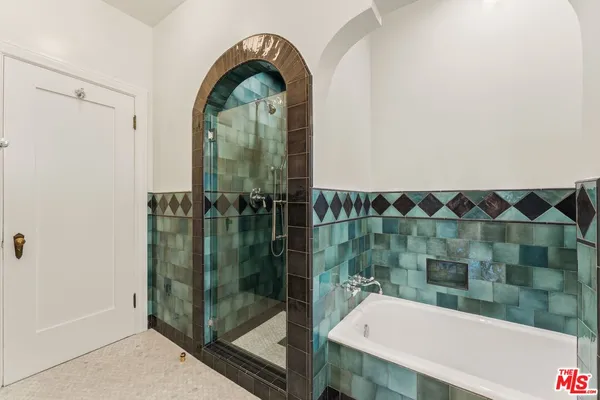 a bathroom with a bathtub and a shower