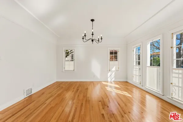 a big room with wooden floor windows and entryway