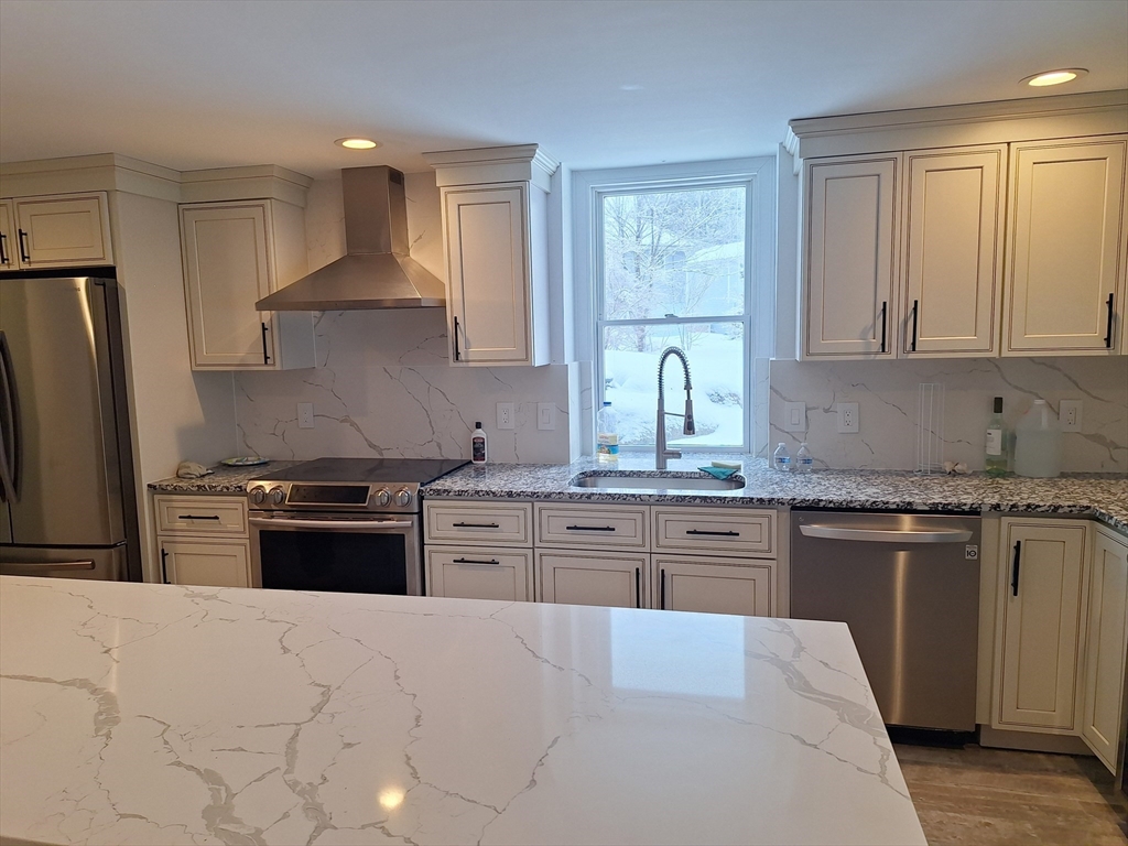 48 Gee Avenue, Unit B Gloucester, MA 01930 - Photo 2 of 12 a kitchen with granite countertop stainless steel appliances a stove sink and refrigerator