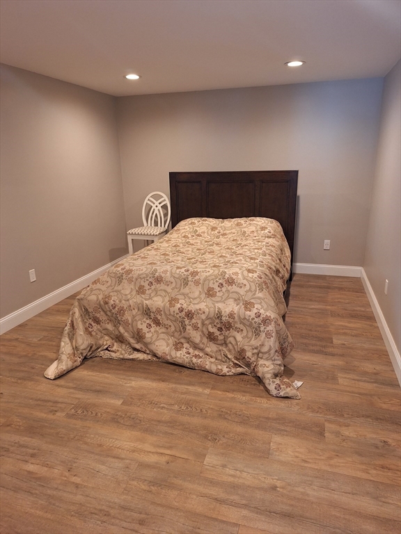 48 Gee Avenue, Unit B Gloucester, MA 01930 - Photo 6 of 12 a bedroom with a bed and a wooden floor