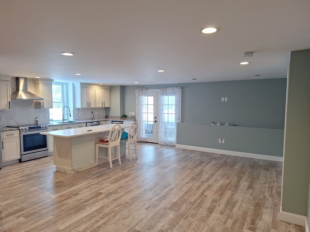 48 Gee Avenue, Unit B Gloucester, MA 01930 - Photo 7 of 12 a large kitchen with a table and chairs