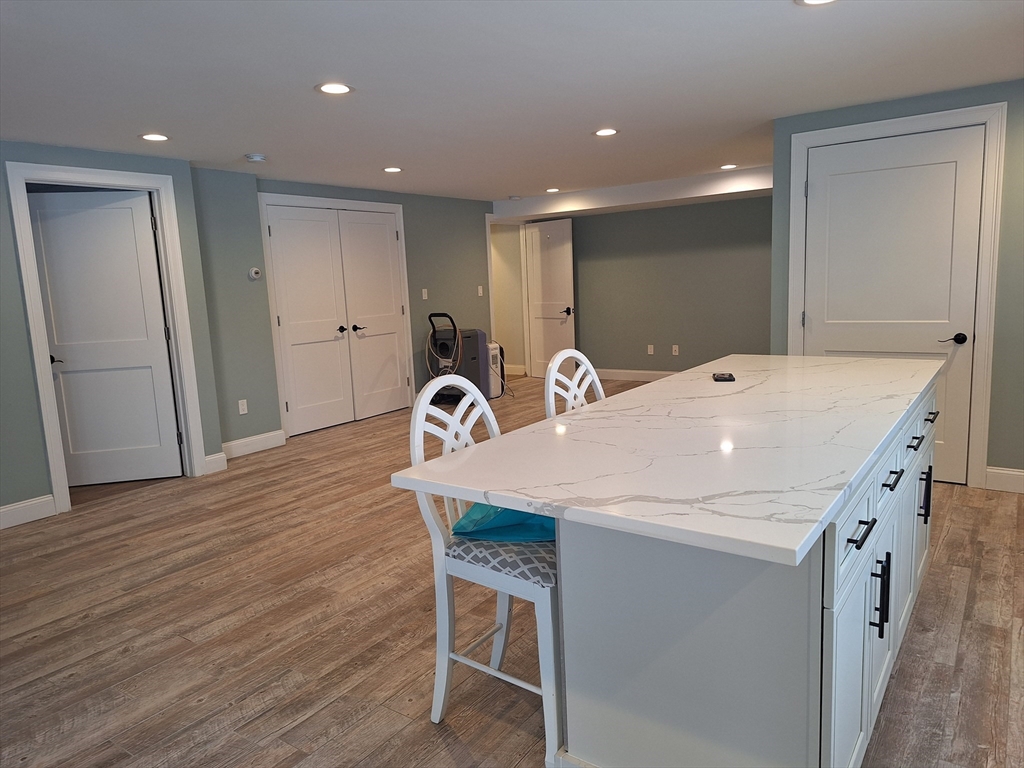 48 Gee Avenue, Unit B Gloucester, MA 01930 - Photo 9 of 12 a kitchen with a table chairs sink and wooden floor