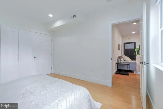 a bedroom with a bed and a view of hallway