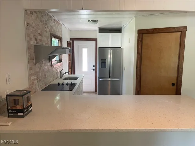 a kitchen with stainless steel appliances a refrigerator and a stove