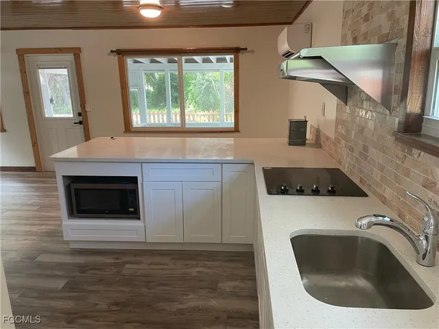 a kitchen with a sink and a stove