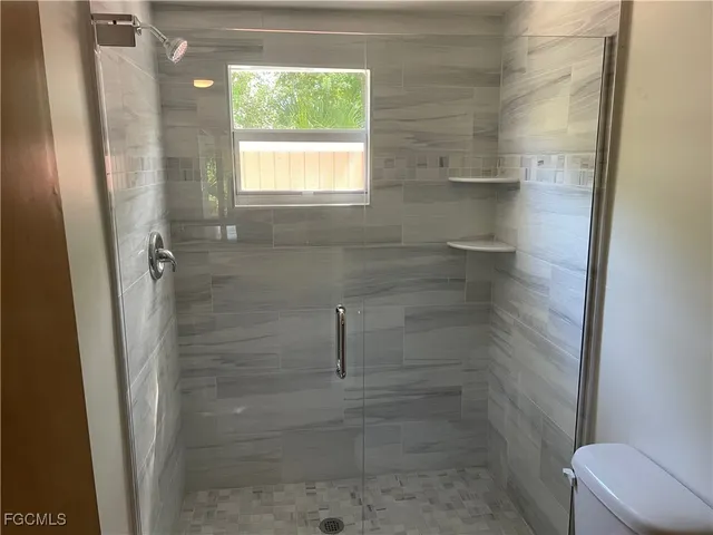 a bathroom with a shower and toilet