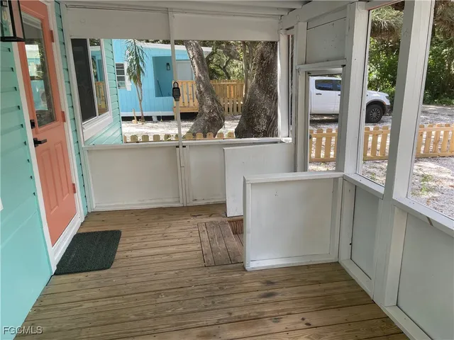 a view of counter top space with wooden floor and fan