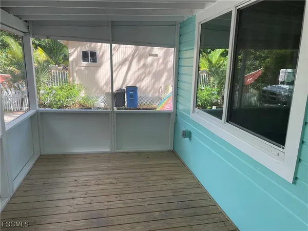 a view of a porch with wooden floor and outdoor space