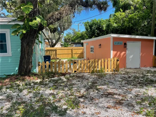 a view of a backyard with a large tree
