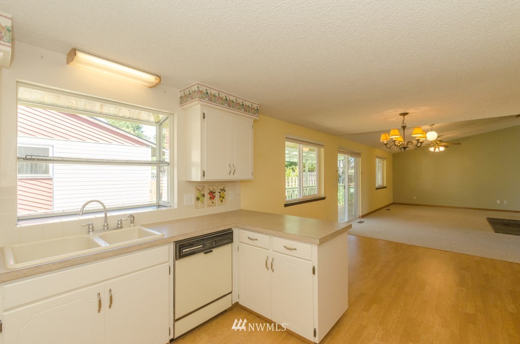 157 Galaxie Road Chehalis, WA 98532 - Photo 11 of 21 a view of a kitchen with a sink wooden cabinets and a window