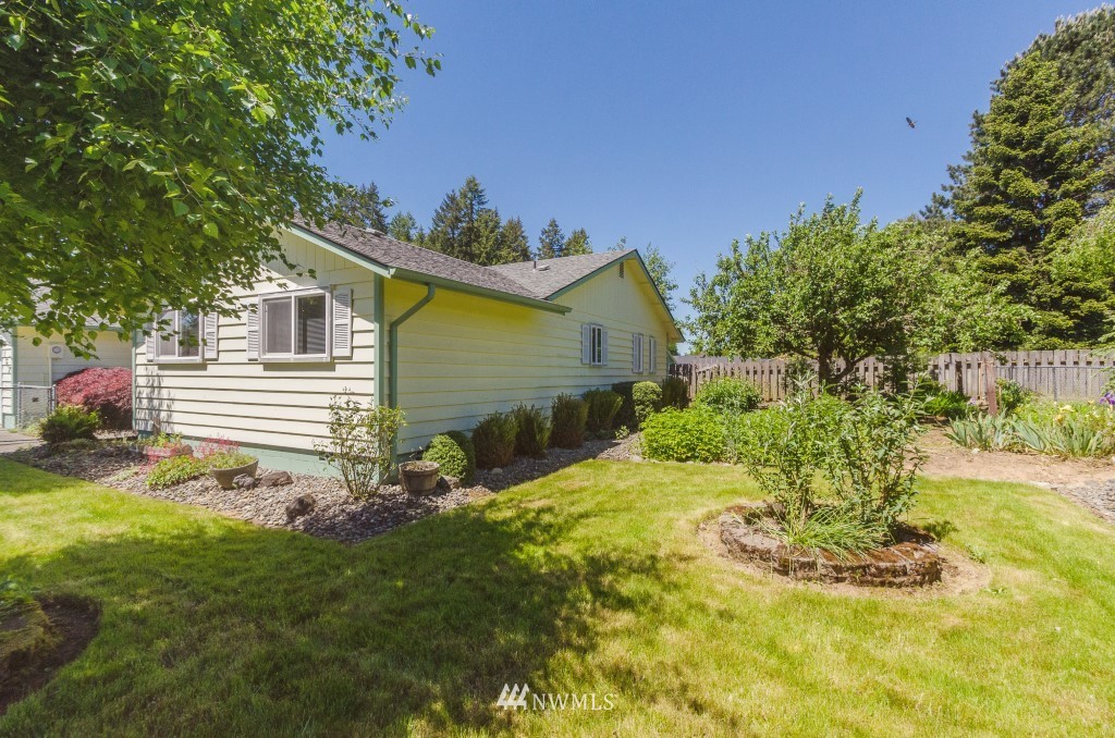 157 Galaxie Road Chehalis, WA 98532 - Photo 16 of 21 a view of a backyard with plants and a small cabin