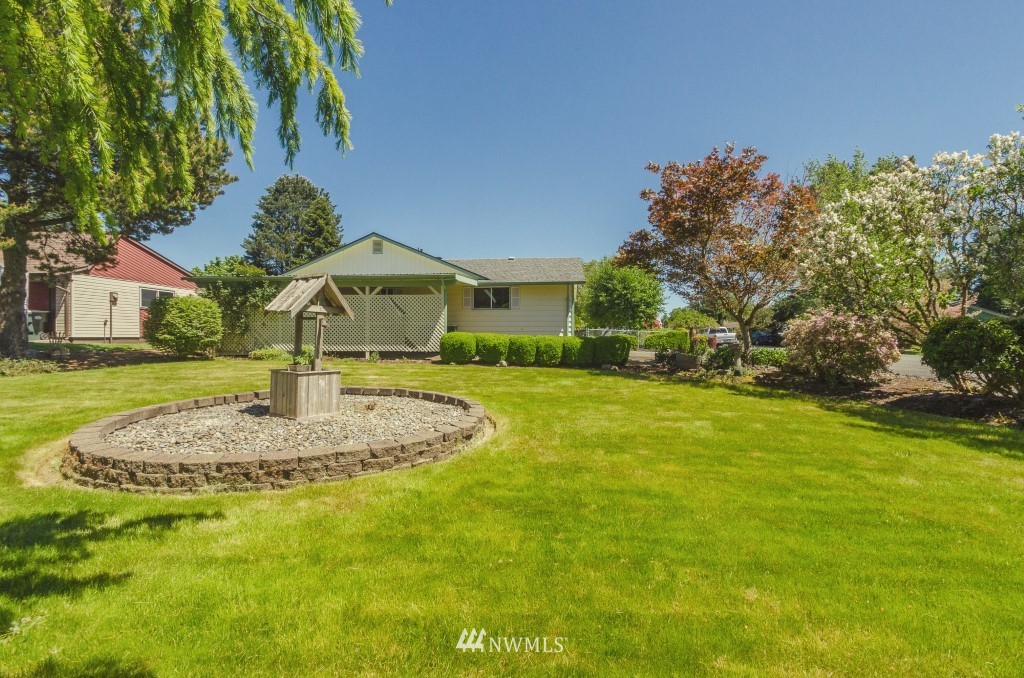 157 Galaxie Road Chehalis, WA 98532 - Photo 20 of 21 a front view of a house with a garden and yard
