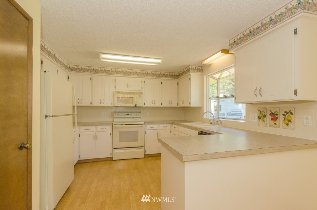157 Galaxie Road Chehalis, WA 98532 - Photo 10 of 21 a kitchen with stainless steel appliances granite countertop a sink and a stove with white countertops