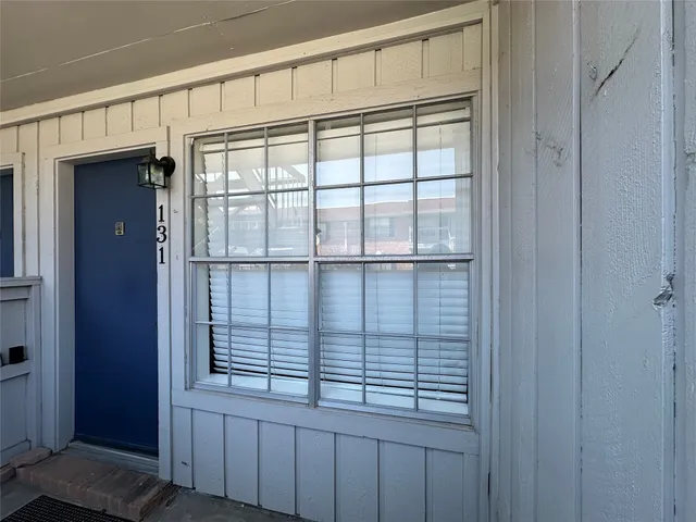 a view of wooden floor and windows in a room