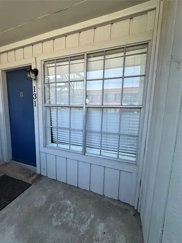 a pathway of a house with wooden fence