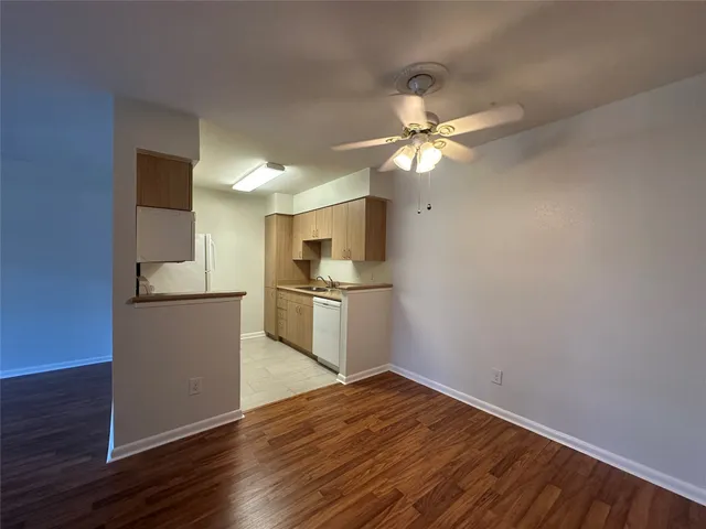 a kitchen with a refrigerator and a stove top oven