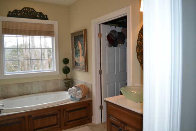 795 Sanders Mill Road Burns, TN 37029 - Photo 11 of 20 The luxurious master bath has seoerate his and hers vanities a fabulous soaking tub and large shower.